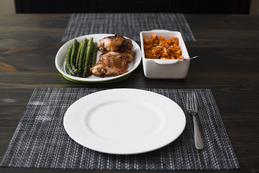 Completed high-protein meal plate with portioned chicken, roasted vegetables, and rice