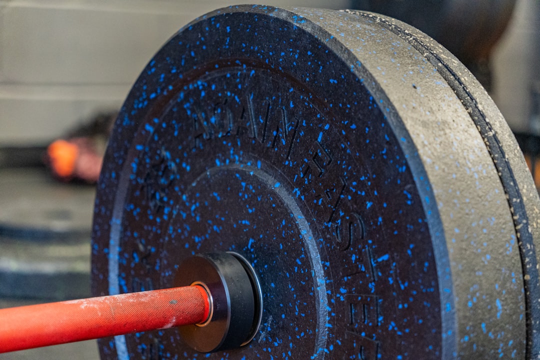Loaded Olympic barbell with weight plates in squat rack setup