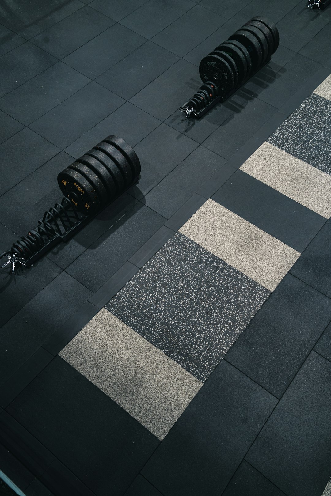 Adjustable dumbbell on protective interlocking foam mat for apartment floor damage prevention