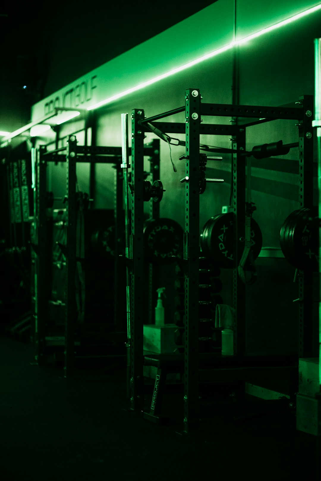 Loaded barbell in squat rack representing strength training progression from creatine supplementation